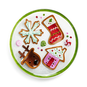 A round glass plate with the image of Christmas sugar cookies and a green rim.
