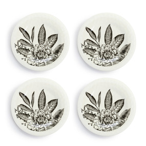 A set of four white melamine appetizer plates with black line drawn flowers in the middle, displayed set out next to each other.
