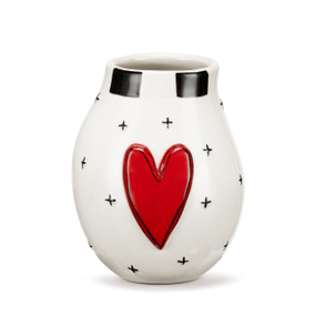 A white ceramic vase with a raised red heart on the front and small black crosses around the vase.