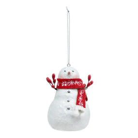 A white snowman ornament with red berry branch arms and a red scarf.