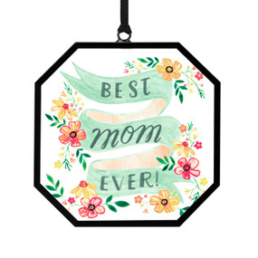 A small octagon shaped sun catcher with illustrated flowers and a green banner that says "Best Mom Ever!".