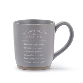 A gray blue ceramic mug with a saying about "Pooh's Guide for a Good Day".
