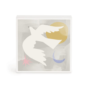 A small white box artwork of a white bird in flight by a yellow sun and blue crescent moon all on a gray background.