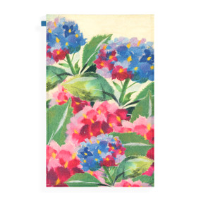 A tea towel with artwork inspired by ArtLifting artist Midori of pink and blue hydrangea flowers.