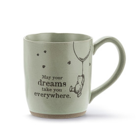 A green ceramic mug with an illustration of Pooh hanging from a balloon and the saying "May your dreams take you everywhere".