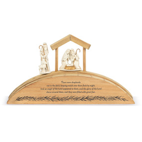 A wood Advent countdown calendar with a Bible verse on the front. There is a shepherd figure and holy family figure.