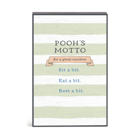 A green and white striped wall art with a message about Pooh's motto for a great vacation.