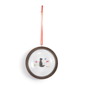 A hanging glass dome ornament on a wood base. The inside has a pebble image of a cat surrounded by holiday lights.
