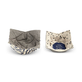 Two fabric bowl holders with gray fabric on one side and a blue and cream stripe on one and blue polka dot fabric on the other that says "Even Better On Day Two", sitting next to each other.