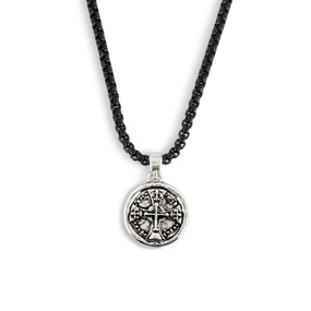Detail view of the charm on a men's black adjustable necklace with a round silver cross charm.