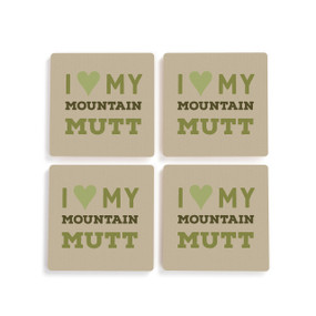 A set of four brown ceramic coasters with the saying "I love my mountain mutt".