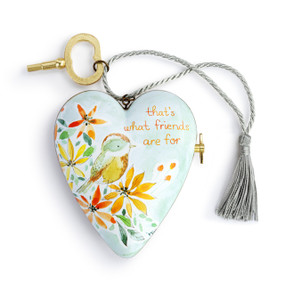 A heart shaped musical sculpture in a light green floral and bird pattern that reads "that's what friends are for". The heart has a silver tassel and gold key attached.