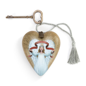 A heart shaped gold sculpture that has an angel under a red ribbon that says "Peace On Earth" with a silver tassel and metal key attached.
