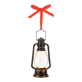 A small traditional looking lantern ornament hanging from a red ribbon.