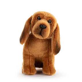 A brown and black plush small bloodhound dog sitting down.