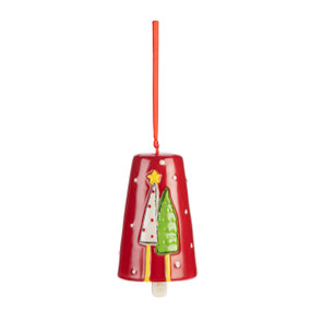 A red ceramic bell with white dots and two patterned trees on the front.