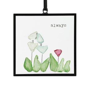 A small square suncatcher with flowers made out of small colored stones and the saying "always".