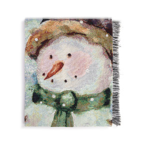 A folded fringed woven blanket with the image of a snowman.