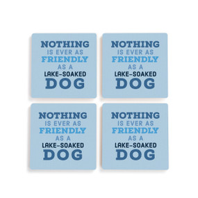 A set of four blue ceramic coasters with the saying "Nothing is ever as friendly as a lake-soaked dog".