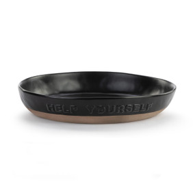 A black ceramic serving bowl that says "Help Yourself" on the front. The bowl has a tan textured base.