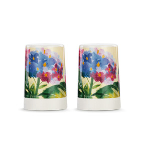 A set of two white ceramic salt and pepper shakers with a cream textured base. There is an image of pink and blue hydrangeas on them.