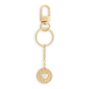 A gold metal keychain with a round gold locket attached. The locket has a silver heart in the center.
