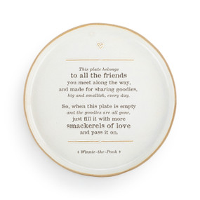 A round white ceramic plate with a tan edge and a saying about sharing goodies with friends with a reference to Winnie-the-Pooh.
