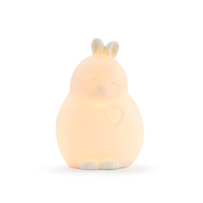 A ceramic bunny shaped night light displayed lit up.