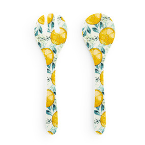 A large white plastic set of two serving utensils with an illustrated lemon pattern.