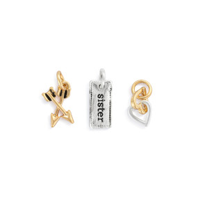 A set of three different gold and silver charms related to sisters.
