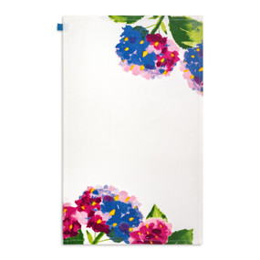A white kitchen towel with illustrations of pink and blue hydrangea flowers displayed with the towel laid out flat.