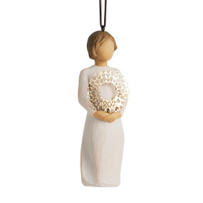 Front view: Dated Ornament of figure holding pierced gold-leaf wreath of hearts. 2024 written on wreath; loop and hook in head