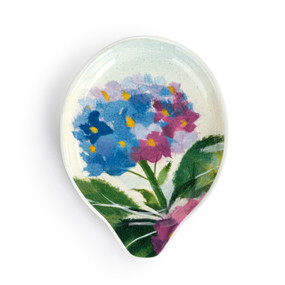 A ceramic spoon rest with blue and purple hydrangea artwork inspired by ArtLifting artist Midori.