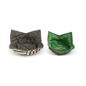 Two fabric bowl holders with gray fabric on one side and a cream with black stripes on one and a green one with a football on the other that says "Eat Drink Game Day", sitting next to each other.