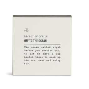 A white square wall art with the saying "RE: Out of Office Off to the Ocean" with a short write up about someone on an ocean vacation.