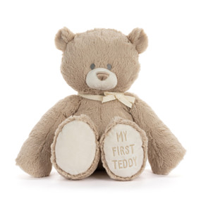 A brown plush bear with "My First Teddy" embroidered on the paw of his left leg.
