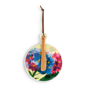 A round ceramic mini serving board with an image of pink and blue hydrangea. The board has a small wood knife attached.