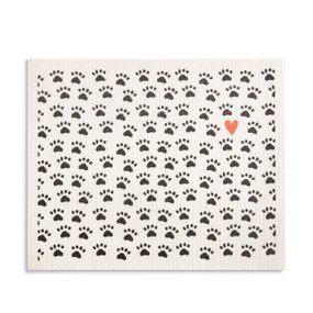 An oversized white biodegradable dish cloth with illustrated black pawprints and one red heart.