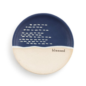 A small round blue and tan ceramic trinket dish. The blue is on the top half and the word "blessed" is on the right middle.