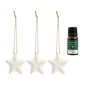 A set of three hanging white ceramic diffusers shaped like stars that come with a small bottle of Douglas Fir fragrance oil.