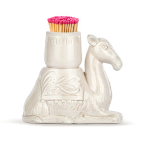 A cream ceramic kneeling camel with a container on its back meant for holding matches.