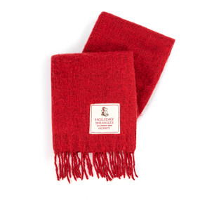 A red fringed blanket with a white fabric patch that says "Holiday Snuggles are sweeter than Hunny" with an image of Pooh and Piglet.