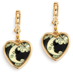 A pair of gold dangling earrings with a heart shaped charm and an illustration of the man in the moon inside.
