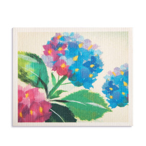 An oversized white biodegradable dish cloth with a pink and blue hydrangea flower image.