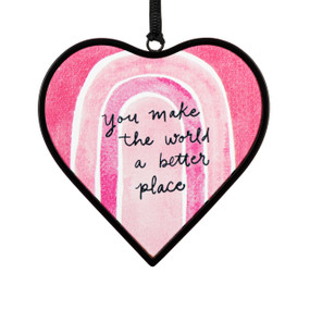 A small pink heart shaped sun catcher with a rainbow illustration and the saying "you make the world a better place".