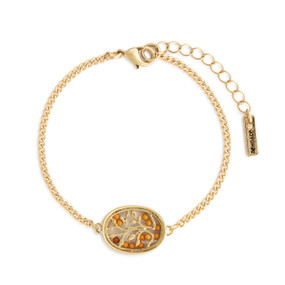 A gold chain bracelet with an oval gold tree and mustard seed charm.