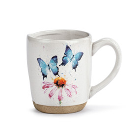 A white ceramic mug with a tan textured base. The mug has a watercolor image of blue butterflies and a purple flower.