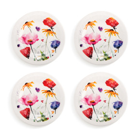 A set of four white appetizer plates with watercolor wildflowers on them.