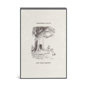 A wall art illustration of Pooh and friends at the tree with the saying "Sometimes, love is just being together".