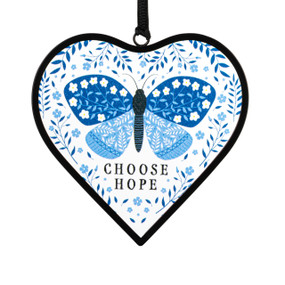 A small blue and white heart shaped sun catcher with a butterfly illustration and the saying "Choose Hope".